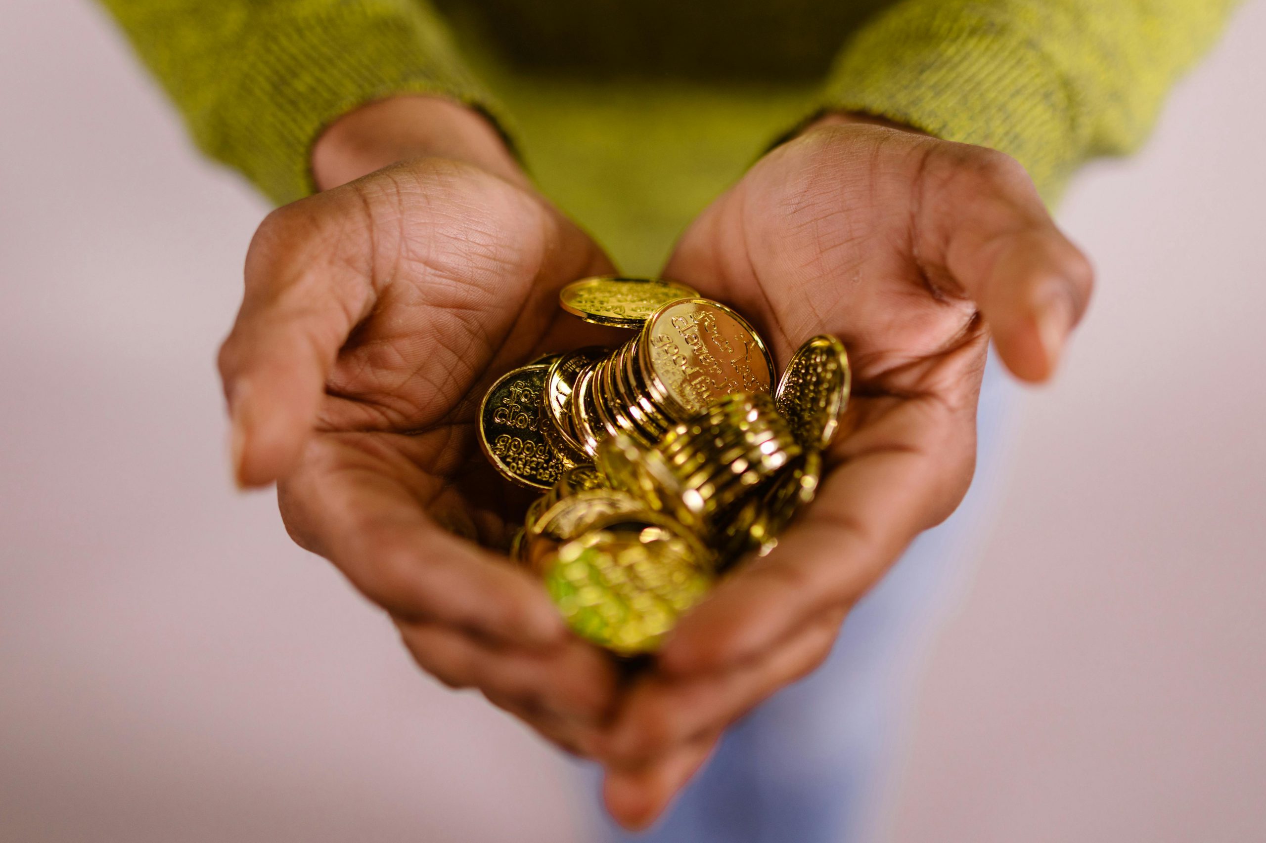 A Hand full of gold coins